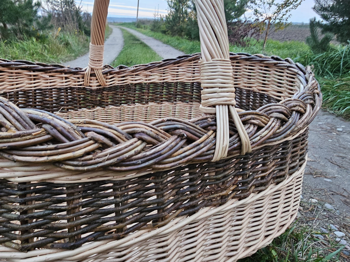 Close-up of the braided unpeeled willow rim and the wrapped handle of the large oval basket