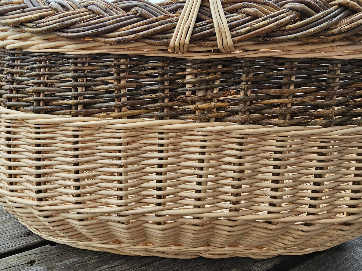 Side close-up of the weave of the large oval basket below the braided rim