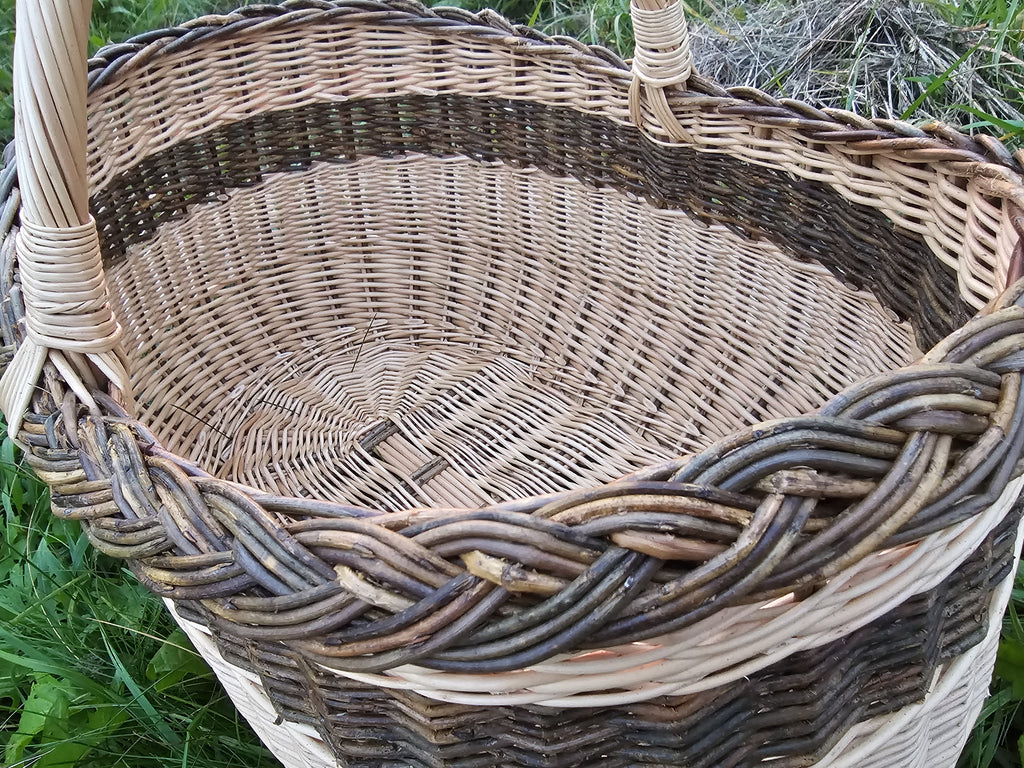 Inside view of the large oval basket showing the woven base and the braided unpeeled willow rim