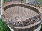 Inside view of the large oval basket showing the woven base and the braided unpeeled willow rim